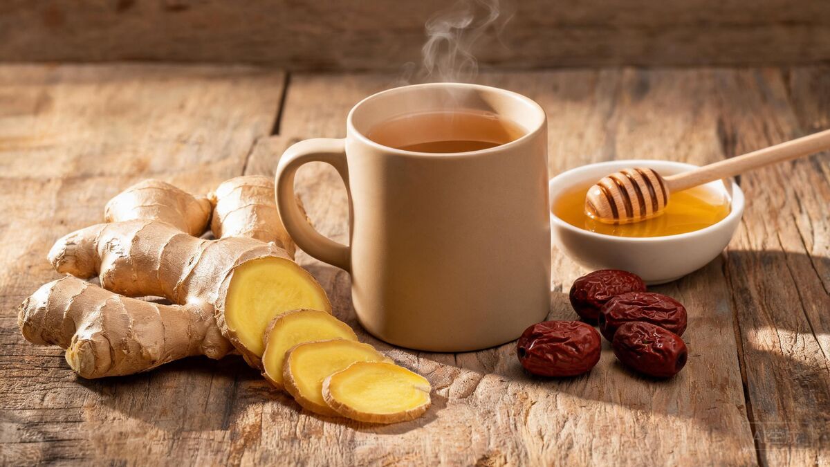 Fresh ginger root and a cup of steaming ginger tea